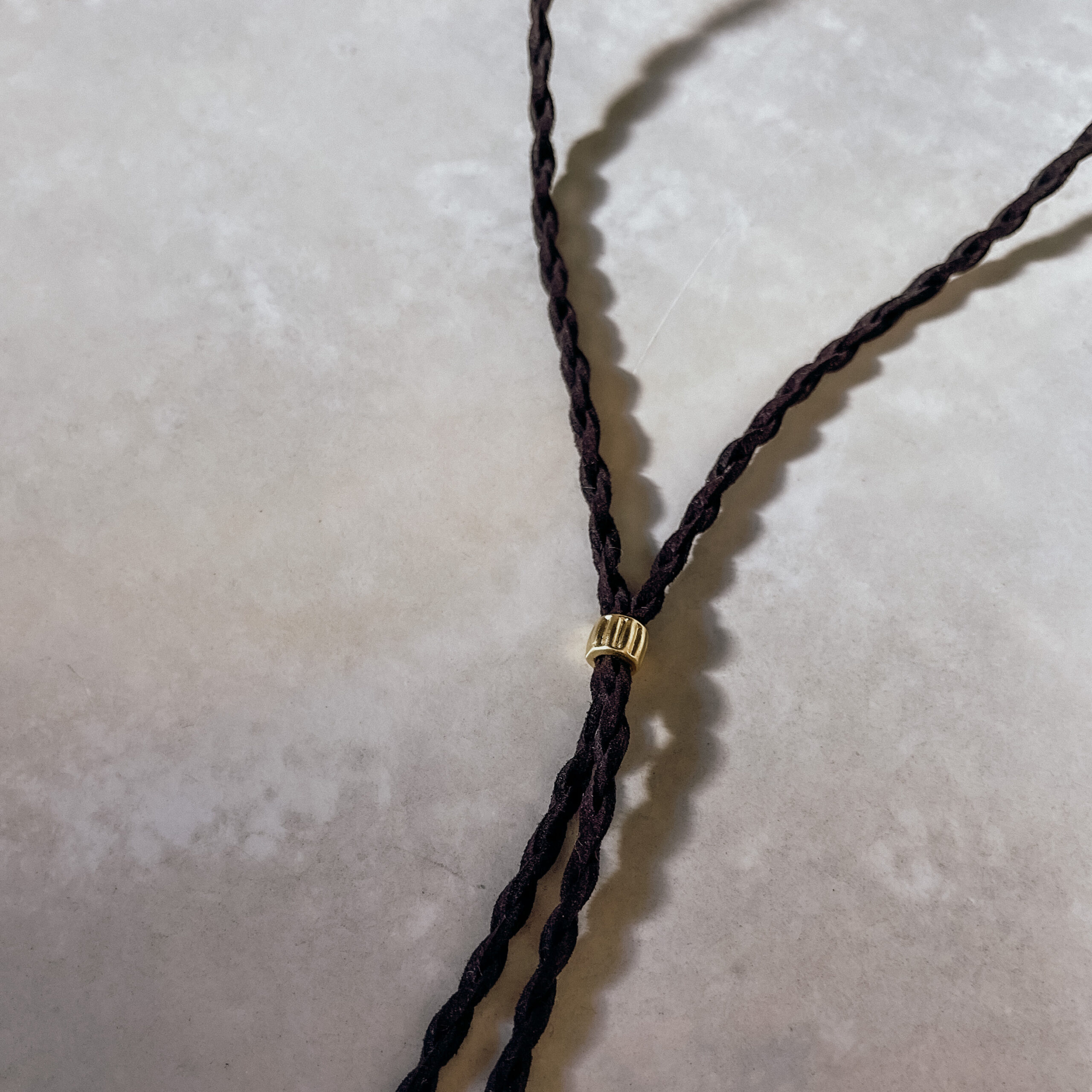 A beautifully handcrafted Crown of the Vagabond hat by the hatters Ruth and Chris on Mallorca with traditional tools in the color Sequoia shaped in Gold Digger and a pinch in the front with a clean simple look inspired by the Spanish horse back riding style consisting of a corded leather string also used as a chinstrap fixed with a golden pearl and golden rivets in the front of the crown and a clean flat brim - branded with the serial number 21.