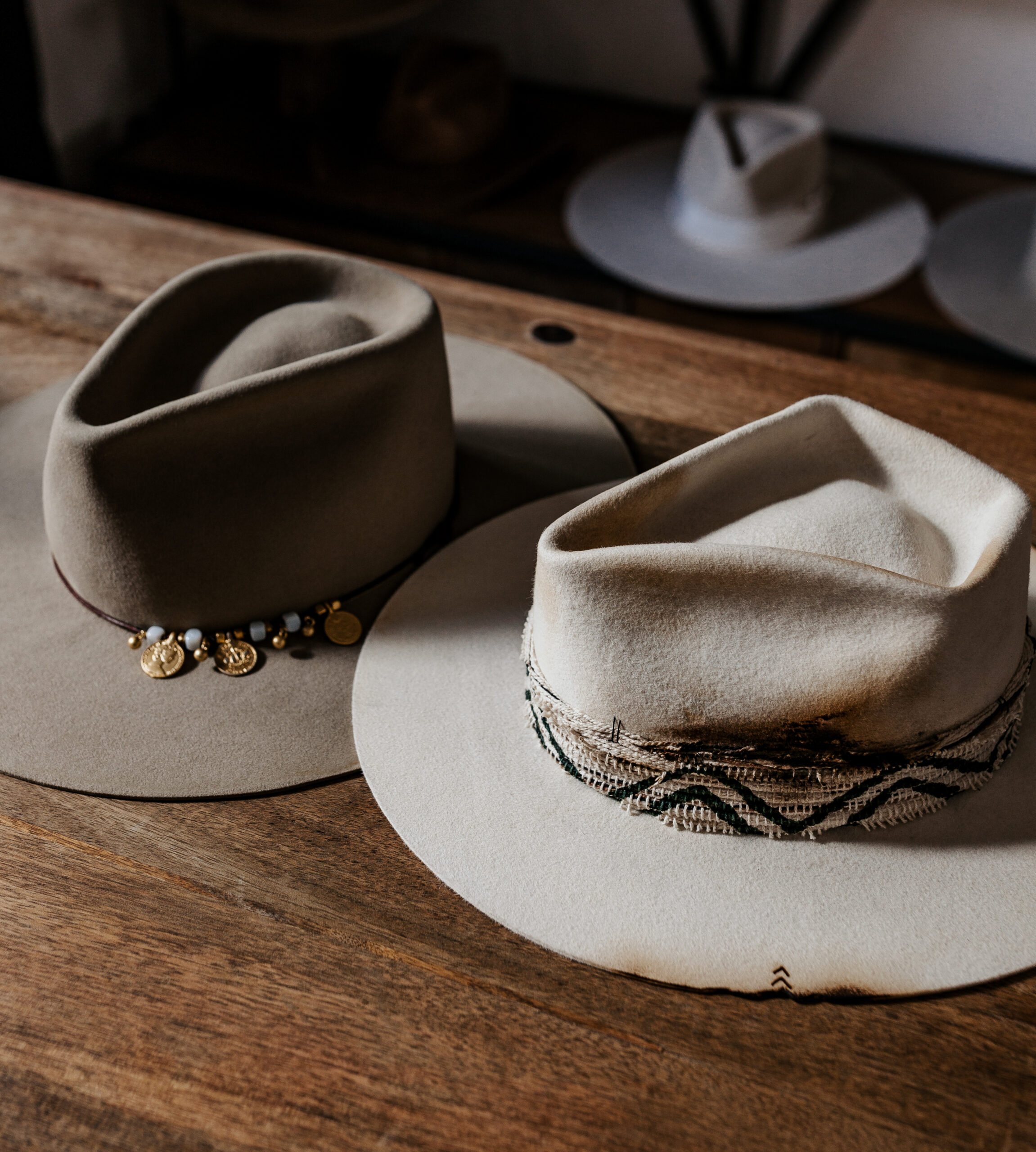 A beautifully handcrafted Crown of the Vagabond hat by the hatters Ruth and Chris on Mallorca with traditional tools in the color Snow shaped in Stargazer with a rough adventurer look mostly distressed consisting of a woven thick headband with stitches on crown and band as well as custom laser branding on crown and brim near the cutouts. The flat brim has cutouts as well as burn marks all over and the sweatband wears the number 28.