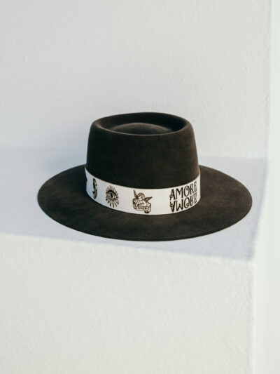 Amore - for all true basherts. Color Tortuga comes in an Oasis shape. Stylish leather hatband crested with hand-drawn signature Tattoos.